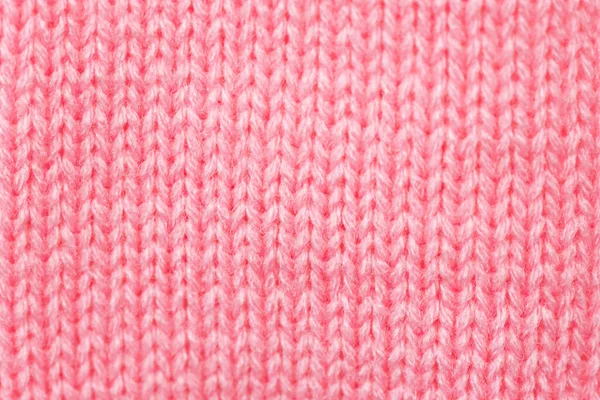 Red knitted fabric texture background. Top view.