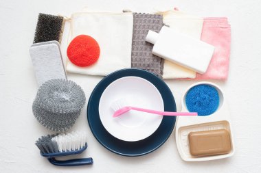 Beyaz arka planda bulaşık yıkama aksesuarları. Temizlik konsepti.