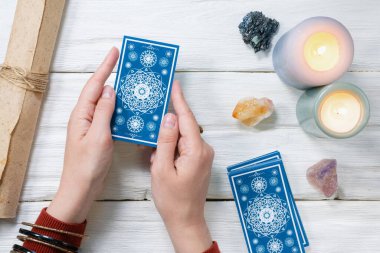 Falcı kartlarındaki tarot kartları beyaz ahşap masa arkasında. Gelecek okuma.