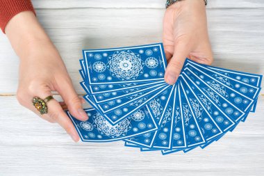 Falcı kartlarındaki tarot kartları beyaz ahşap masa arkasında. Gelecek okuma.