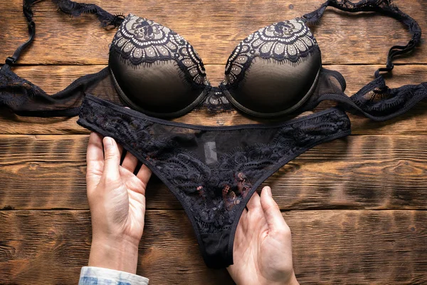 Woman Holding Hands Black Lingerie Panties Close Brown Store Counter — Stock Photo, Image