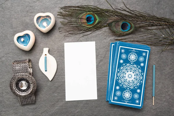 Blue tarot cards deck and blank tarot card with copy space on the stone table surface background.