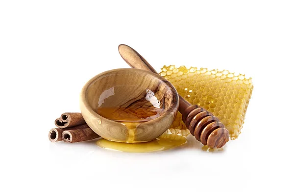 Favo de mel com mel líquido e canela — Fotografia de Stock
