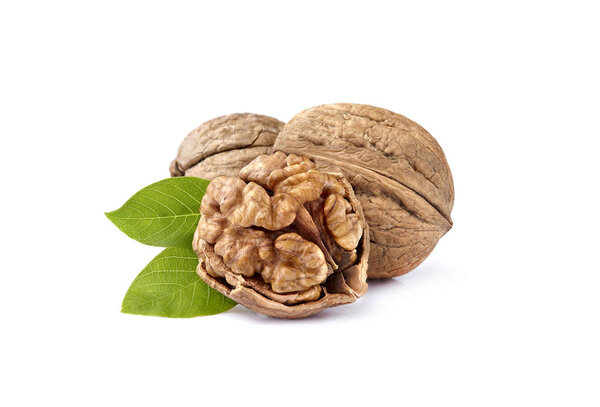 Walnuts in closeup with leaves on white background