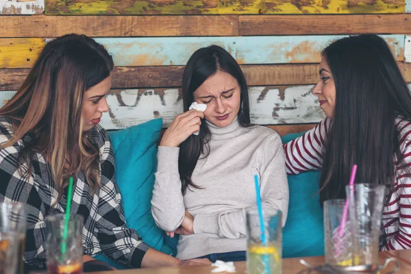 Friends supporting and consoling crying young woman, friendship concept with young millennial girls at restaurant talking about couple problems and divorce  relationship problems of teenagers
