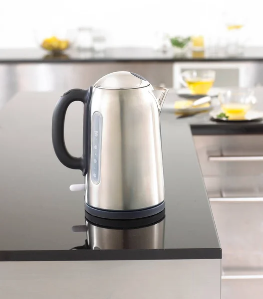 Stylish metal electric kettle in the kitchen interior