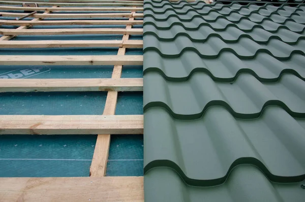 Metal roof tiles, Corrugated metal roof and metal roofing, Green metal roof tiles on the roof