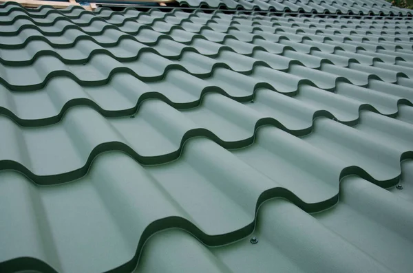 Metal roof tiles, Corrugated metal roof and metal roofing, Green metal roof tiles on the roof