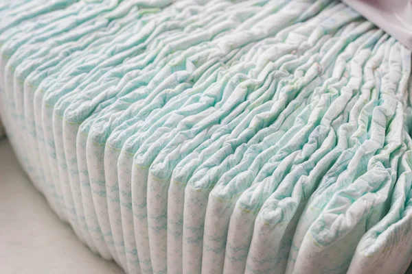 A large stack of baby diapers, close-ups, diaper packaging — Stock Photo, Image