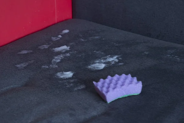foam for cleaning and a sponge on the couch
