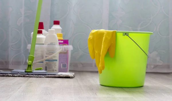 Room cleaning, cleaning equipment, green bucket with gloves