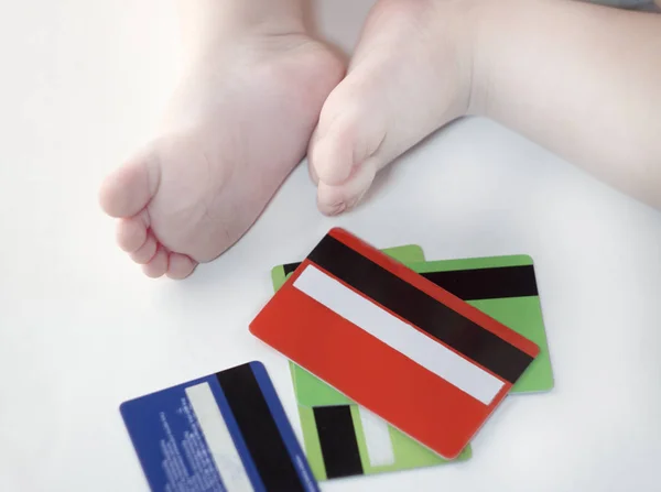 Credit cards and baby feet