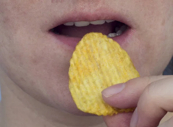Girl eating chips, close-up,