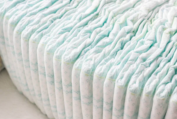 A large stack of baby diapers, close-ups, diaper packaging — Stock Photo, Image
