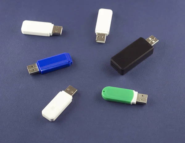 Flash drives of different colors on a blue background