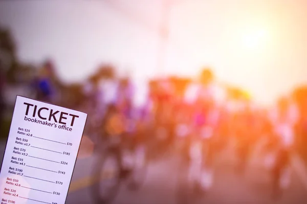 Bookmaker ticket on the background of the TV showing cycling, sports betting, cycling