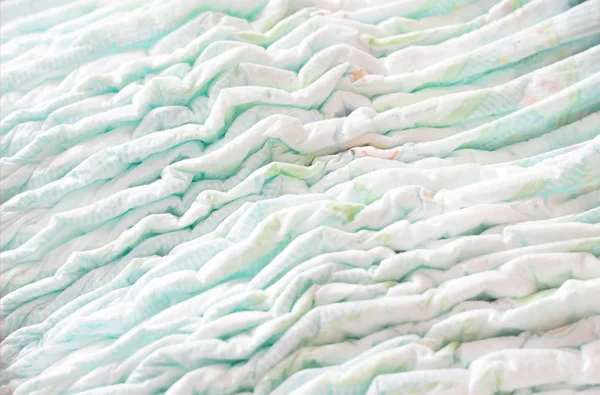 A large stack of baby diapers, close-ups, diaper packaging — Stock Photo, Image