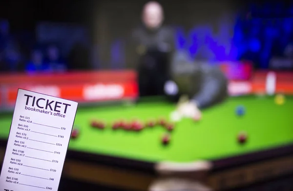 Bookmaker ticket on the background of the TV, which shows a game of snooker, sports betting, bookmaker ticket