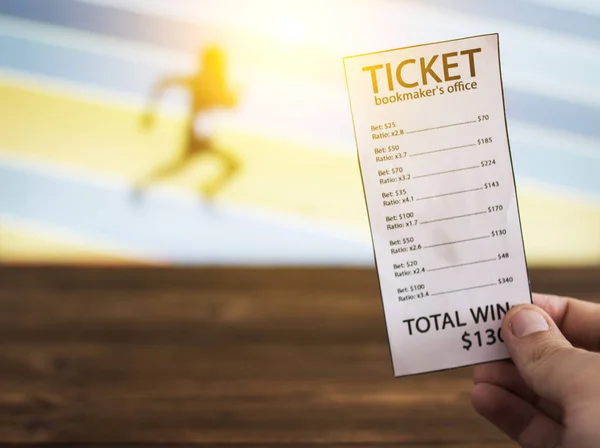 Bookmaker ticket on the background of the TV, which shows athletics, running, jumping, sports betting, Bookmaker ticket — Stock Photo, Image
