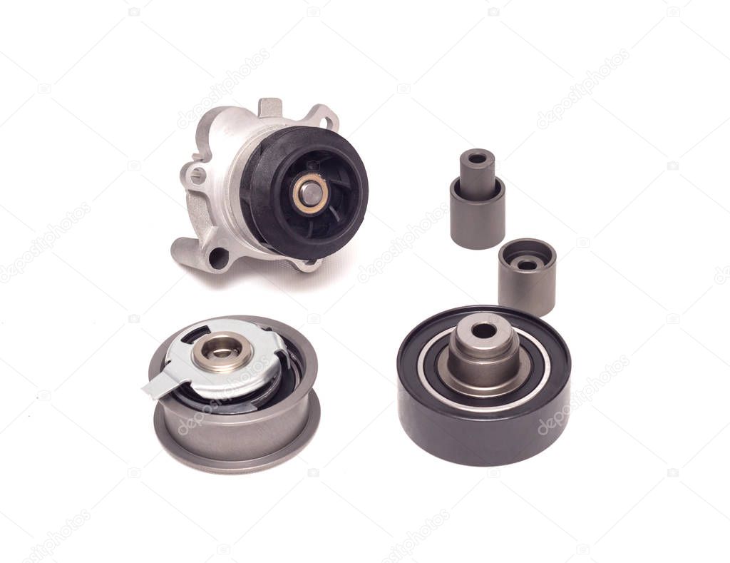 Set of rollers of the automobile engine timing system and the cooling pump on a white background, repair