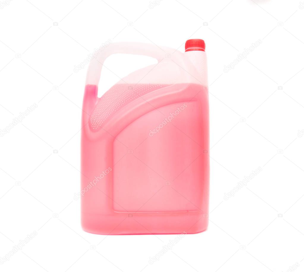 Canister with red antifreeze on a white background, isolate, coolant, close-up