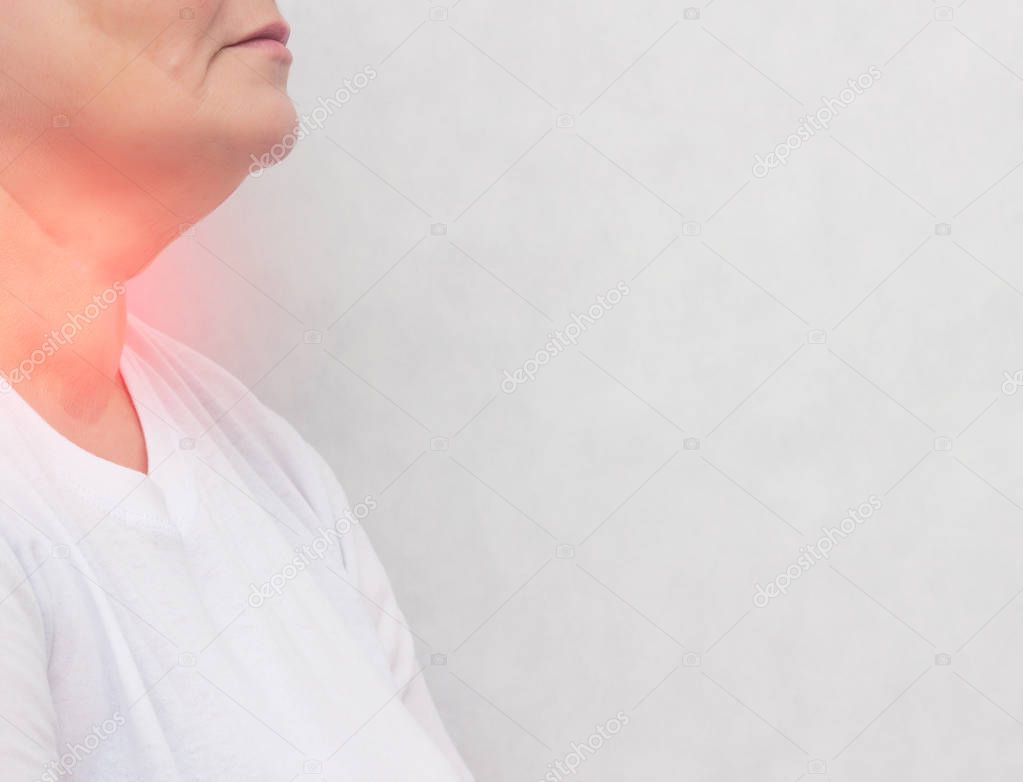 Adult woman who has problems with the thyroid gland, pain, nodes in the thyroid gland, white background, copy space, endocrine system