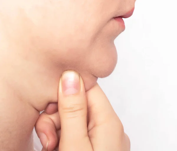 The face of a girl on a white background which keeps itself double chin, obesity, close-up, caucasian