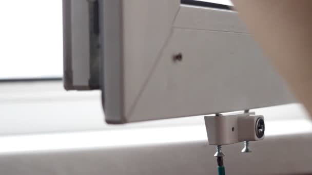The man sets the lock, protection for children against opening the window, security, close-up, installation — Stock Footage The man sets the lock, protection for children against opening the window, security, close-up, installation Video Clip
