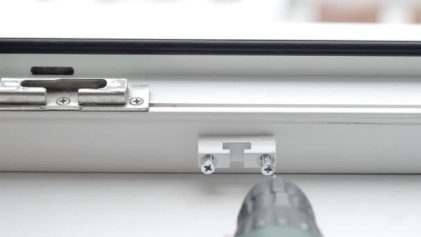 The man sets the lock, protection for children against opening the window, security, close-up, installation — Stock Footage The man sets the lock, protection for children against opening the window, security, close-up, installation Stock Footage
