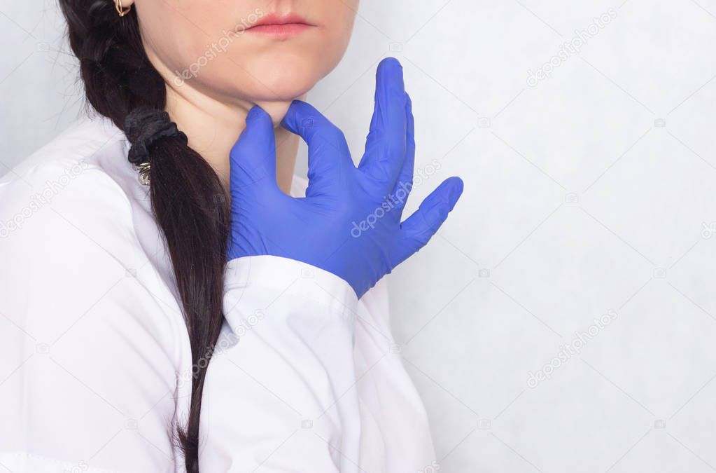 Plastic surgeon delays the girl's double chin, white background, medical, copy space