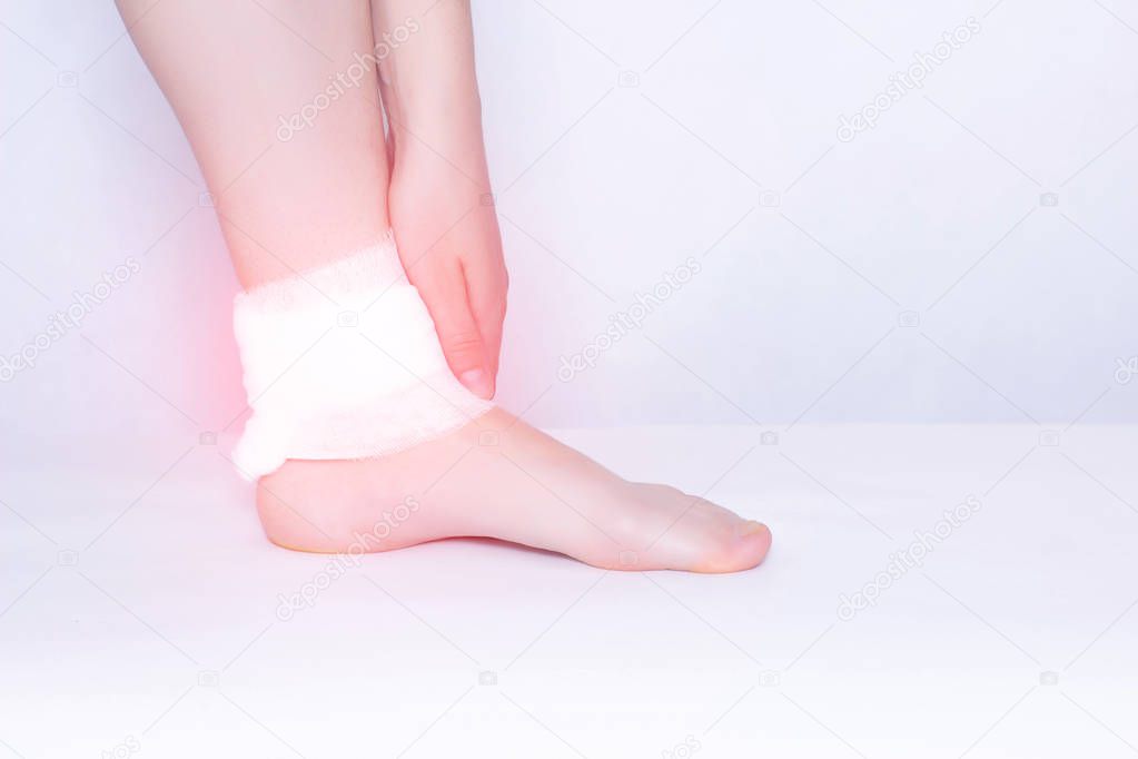 Compress and ankle support to eliminate pain, inflammation and dislocation of the ankle joint, close-up, copy space, osteoarthritis