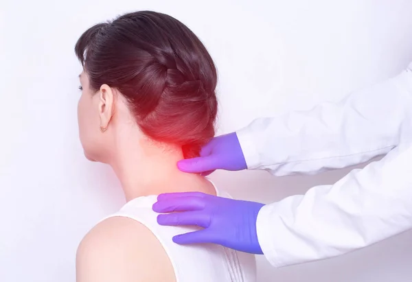 Doctor neurologist examines the patient\'s sore neck on a pinched nerve and protrusion of the spine, medical