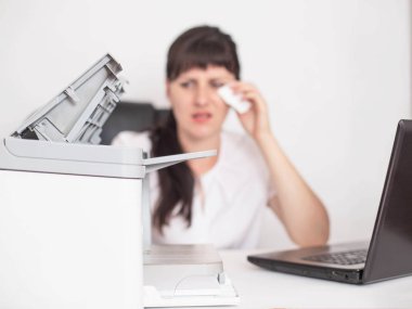 Girl office worker sits wiping tears out of her eyes the concept of office allergies to office equipment and air conditioning, health problems clipart