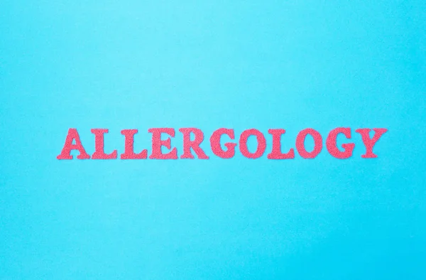 Inscription allergology in red letters on a blue background, section of the medicine. Science studying human allergens, concept of human allergic reactions, background — Stock Photo, Image