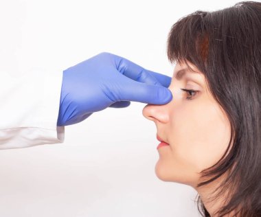 Doktor estetik cerrah, beyaz bir kızı estetik ameliyata hazırlıyor. Burun estetiği.