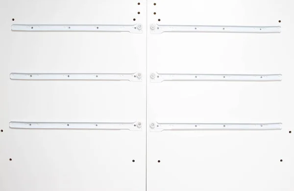 Roller guides for installation during furniture assembly, background, manufacture