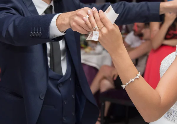 Guests give money to the newlyweds at the wedding