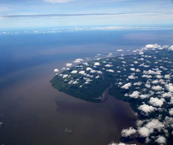 Aerial view of an island that appears to be floating above the ocean