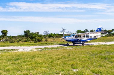 Okavango Deltası, Botsvana - 11 Ocak 2016: Okavango Nehri Deltası'nda küçük turistik uçak, Ulusal Park, Botsvana. Uçak Maun geçidinden parka geliyor.