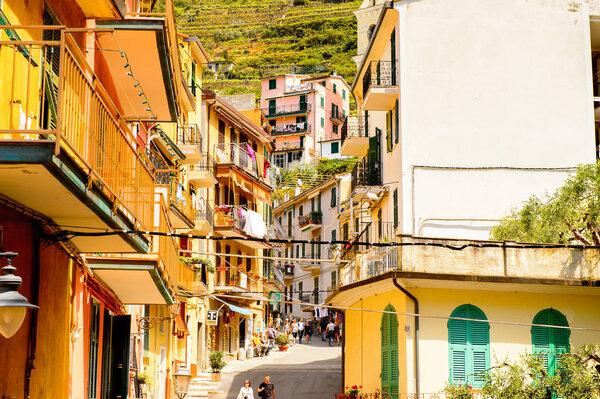 MANAROLA, ITALY - MAY 5, 2016: Main street and its architecture of Manarola (Manaea), La Spezia, Liguria, Italy. It's one of the lands of Cinque Terre, UNESCO World Heritage Site