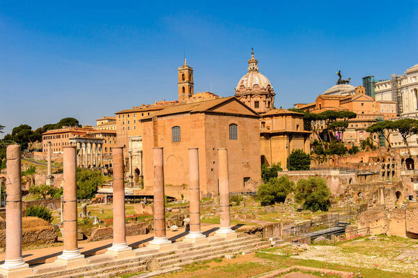 ROME, ITALY - MAY 7, 2016: Roman Forum, a rectangular forum surrounded by the ruins of several important ancient government buildings at the center of the city of Rome.