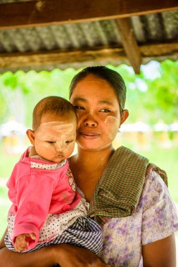 Monywa, Myanmar - 27 Ağustos 2016: Çocuğuyla birlikte kimliği belirsiz Birmanyalı anne. Myanma halkının yüzde 68'i Bamar etnik grubuna mensandı