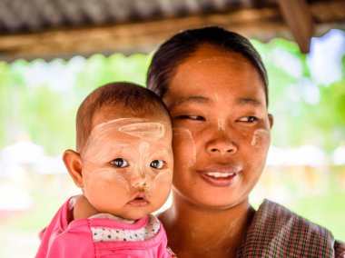 Monywa, Myanmar - 27 Ağustos 2016: Çocuğuyla birlikte kimliği belirsiz Birmanyalı anne. Myanma halkının yüzde 68'i Bamar etnik grubuna mensandı