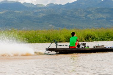 Inle Lake, Myanmar - 30 Ağustos 2016: Myanmar'ın Shan Eyaletinin Taunggyi İlçesi'nin Nyaungshwe İlçesi'nde bulunan bir tatlı su gölü olan Inle Sap'ın üzerinde bambu teknede bulunan tanımlanamayan Birmanyalı adam
