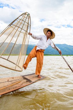 Inle Lake, Myanmar - 30 Ağustos 2016: Özel el yapımı ağı olan bir teknede tanımlanamayan Birmanyalı balıkçı. Bu Myanmar balıkçılık geleneksel yoludur