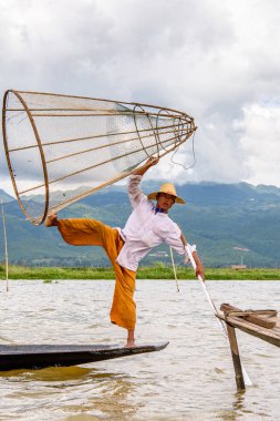 Inle Lake, Myanmar - 30 Ağustos 2016: Özel el yapımı ağı olan bir teknede tanımlanamayan Birmanyalı balıkçı. Bu Myanmar balıkçılık geleneksel yoludur