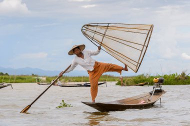 Inle Lake, Myanmar - 30 Ağustos 2016: Özel el yapımı ağı olan bir teknede tanımlanamayan Birmanyalı balıkçı. Bu Myanmar balıkçılık geleneksel yoludur