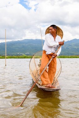 Inle Lake, Myanmar - 30 Ağustos 2016: Özel el yapımı ağı olan bir teknede tanımlanamayan Birmanyalı balıkçı. Bu Myanmar balıkçılık geleneksel yoludur