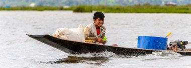 Inle Lake, Myanmar - 30 Ağustos 2016: Myanmar'ın Shan Eyaletinin Taunggyi İlçesi'nin Nyaungshwe İlçesi'nde bulunan bir tatlı su gölü olan Inle Sap'ın üzerinde bambu teknede bulunan tanımlanamayan Birmanyalı adam