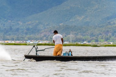 Inle Lake, Myanmar - 30 Ağustos 2016: Myanmar'ın Shan Eyaletinin Taunggyi İlçesi'nin Nyaungshwe İlçesi'nde bulunan bir tatlı su gölü olan Inle Sap'ın üzerinde bambu teknede bulunan tanımlanamayan Birmanyalı adam